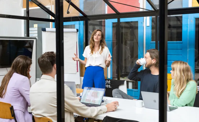 Een team in gesprek tijdens een werksessie rond een tafel
